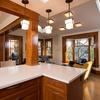 This galley kitchen opens up into the dining & family area.  Architectural millwork matching the rest of the house ensures this open concept design blends with the traditional aesthetic of the home.