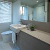 This 8 ft deep x 7 ft wide bathroom benefits from plenty of counter space plus a generous linen closet thanks to the custom vanity, which is more narrow than standard but still offers plenty of storage.